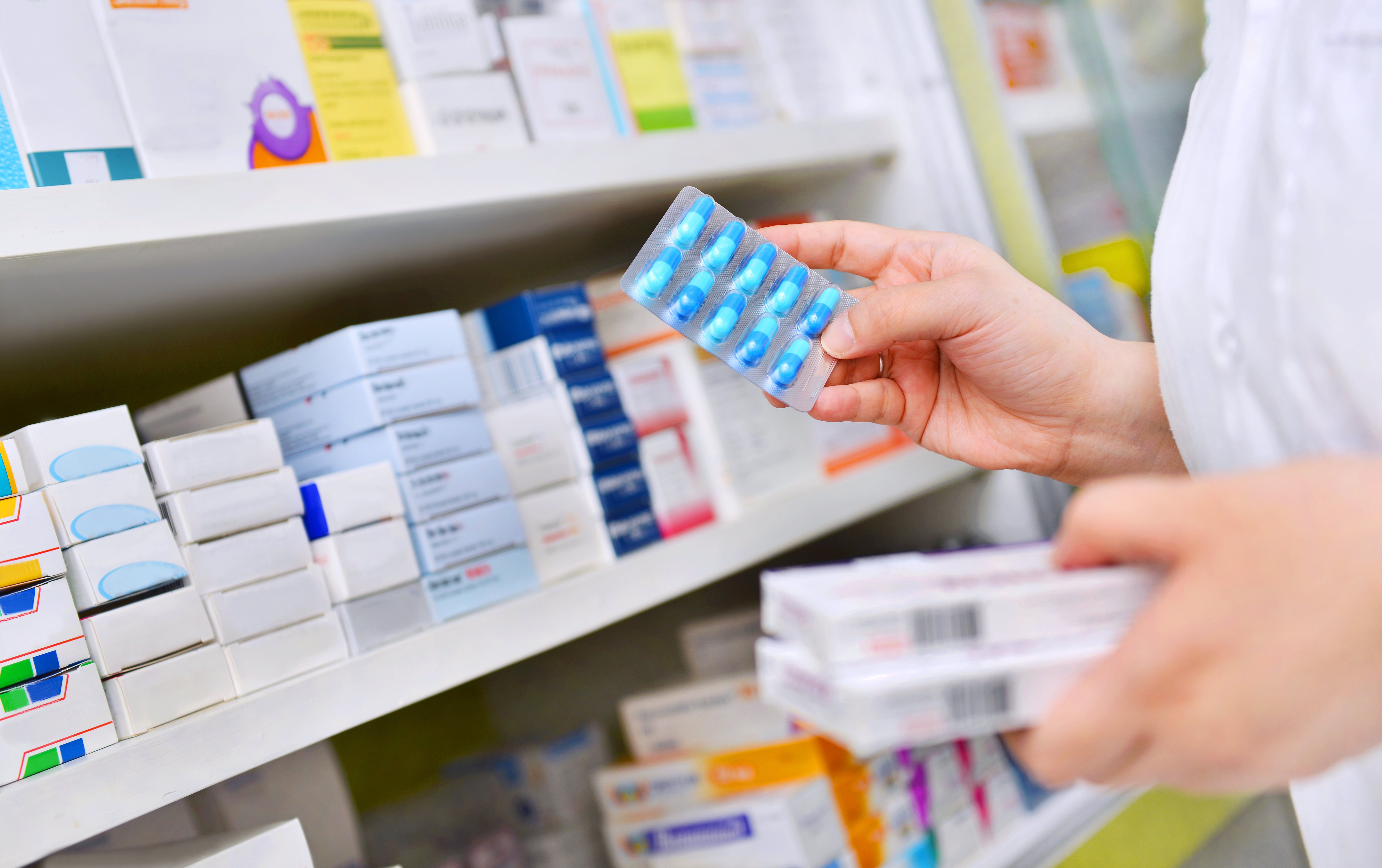 pharmacist-holding-medicine-box-capsule-pack-pharmacy-drugstore